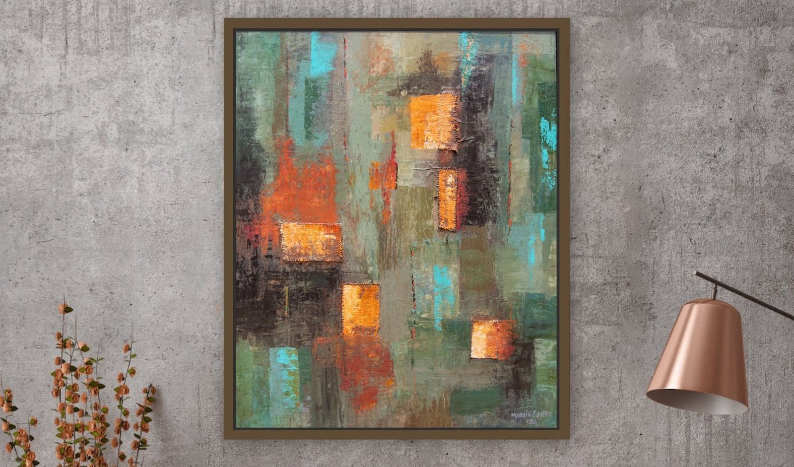 An abstract painting in a natural wood floating frame beside a copper lamp