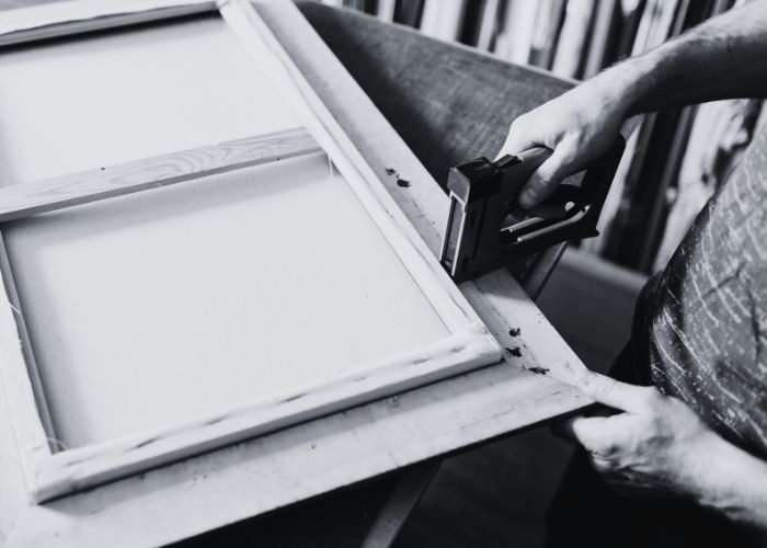 Stapling canvas over a wooden stretcher bar