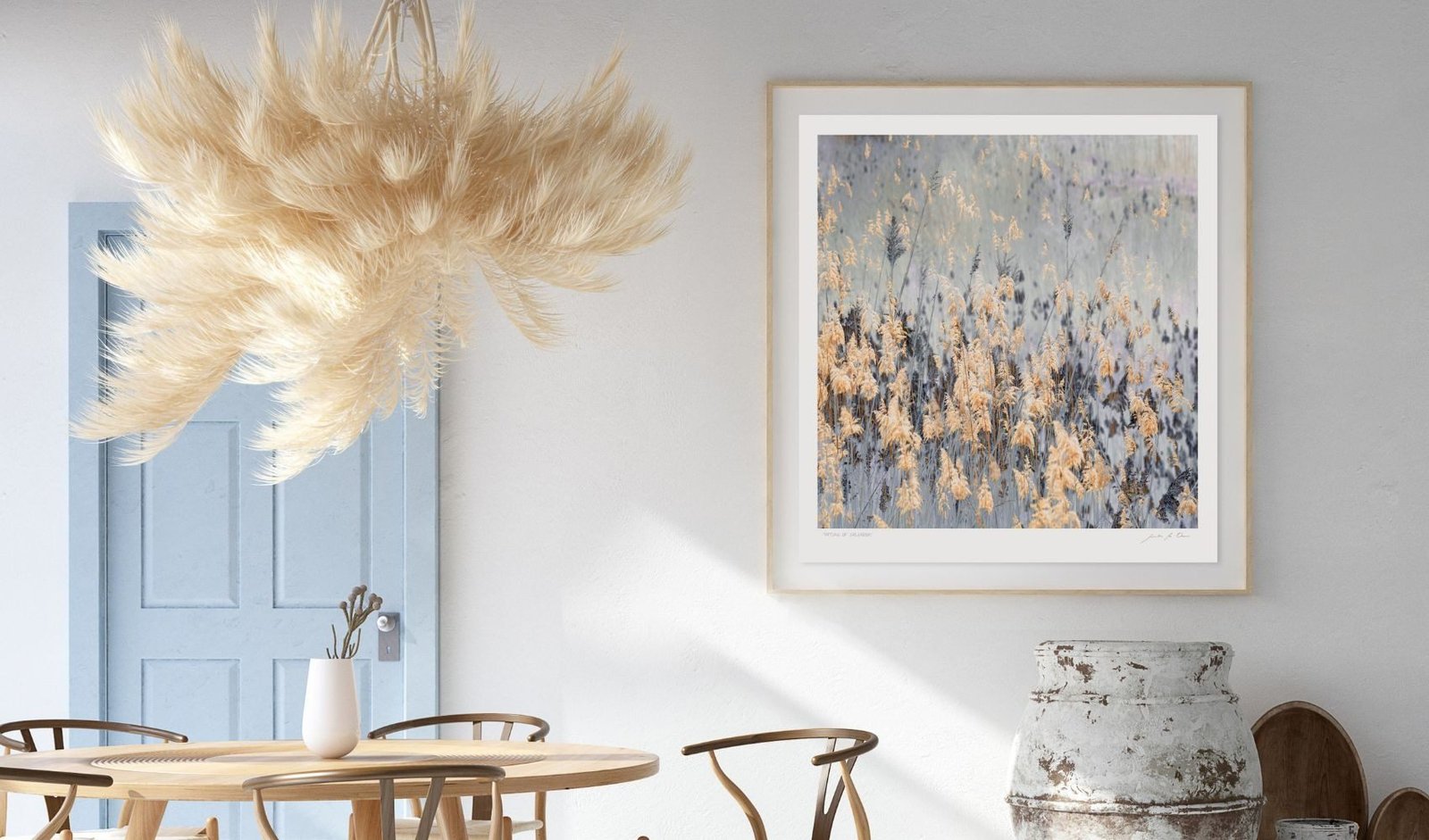 A leaf study in a natural wood frame in a light dining room