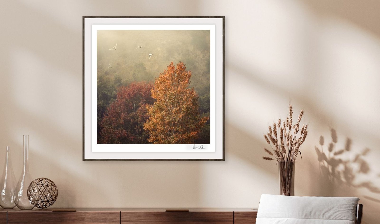 A misty autumn tree in a white frame in a sunlit room