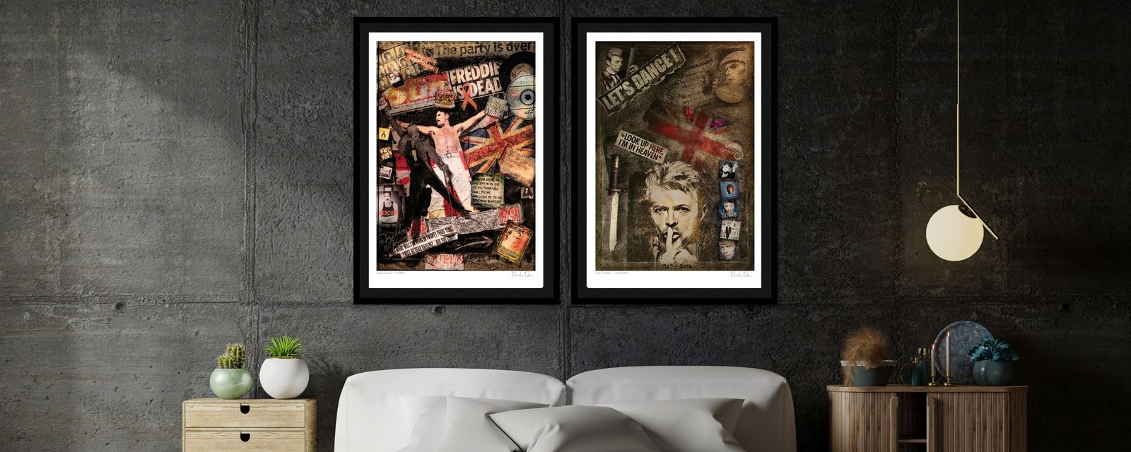 A pair of collage prints in black frames on a concrete wall above a bed