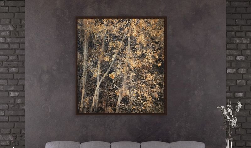 Golden birch trees in a dark frame on a brick wall