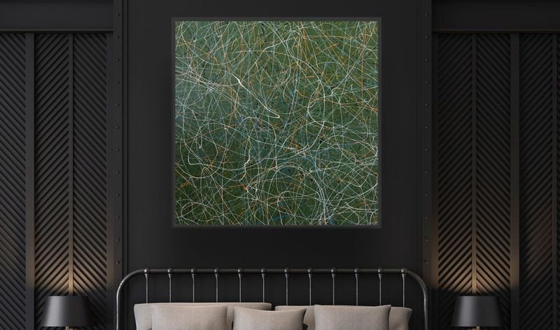Line painting in a dark frame above a bed