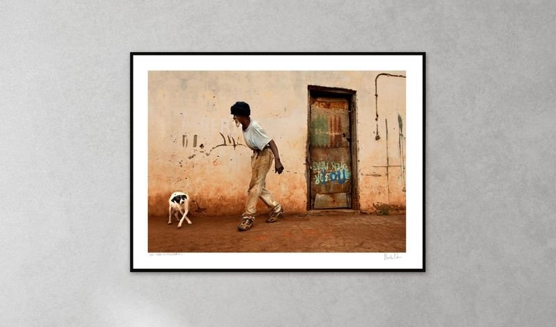 Street photograph in a black frame with a wide white mount