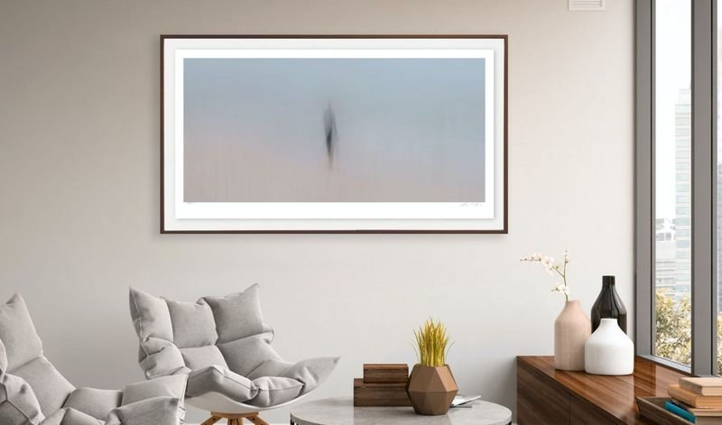 Minimal lake photograph in a white frame in a bright lounge