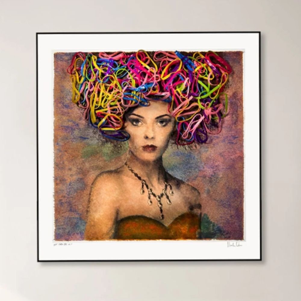 A vivid portrait print in a black frame with a white border