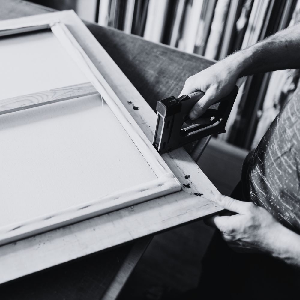 Stapling a canvas to a wooden stretcher frame